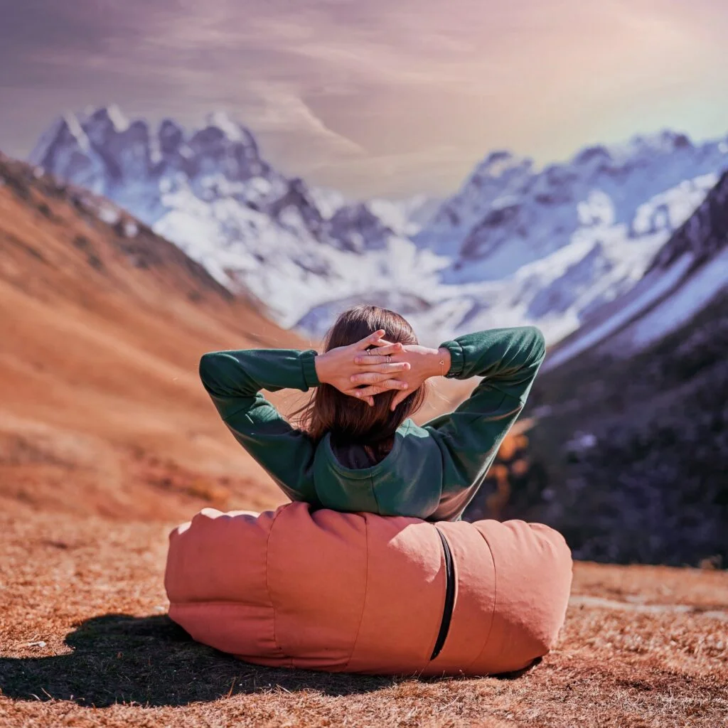 A woman relaxes in the wilderness enjoying epic mountain views, confident that Easy Web Things are sorting out her small businesses website design.