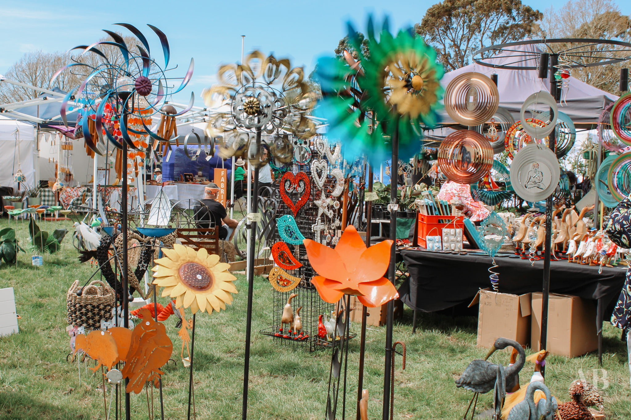 Colourful round garden ornaments that twirl in the wind, set up at the Christmas Country Fete.